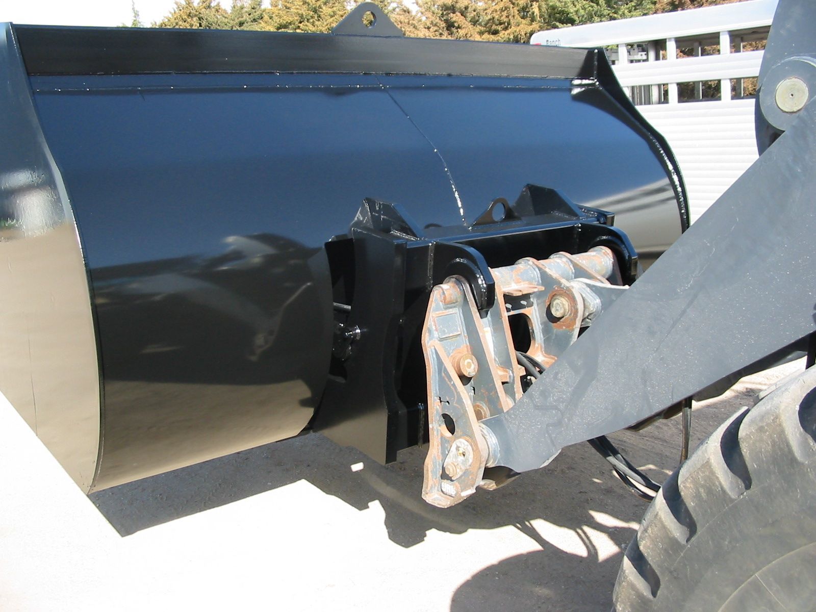 A rollout bucket is attached to a tractor