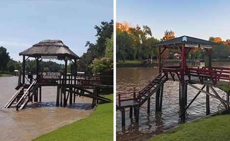 Dos muelles de madera con glorietas sobre un río marrón. Un muelle tiene techo de paja, el otro techo con estructura roja.