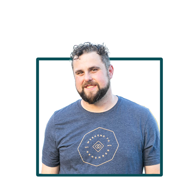 A man with a beard is wearing a blue shirt