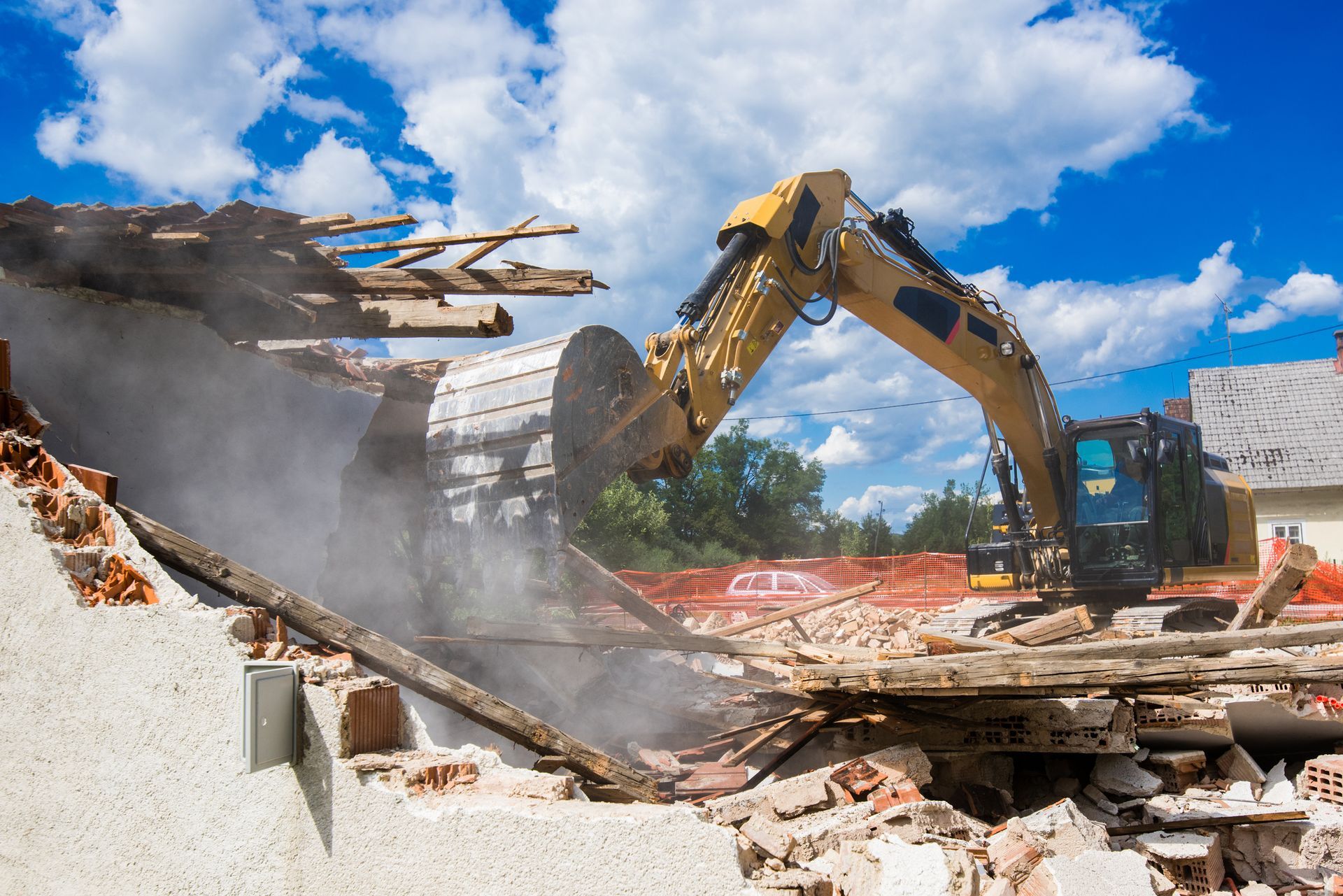The demolition of an old house showcases debris and building demolition contractors at work. The demolition of an old house showcases debris and building demolition contractors at work.