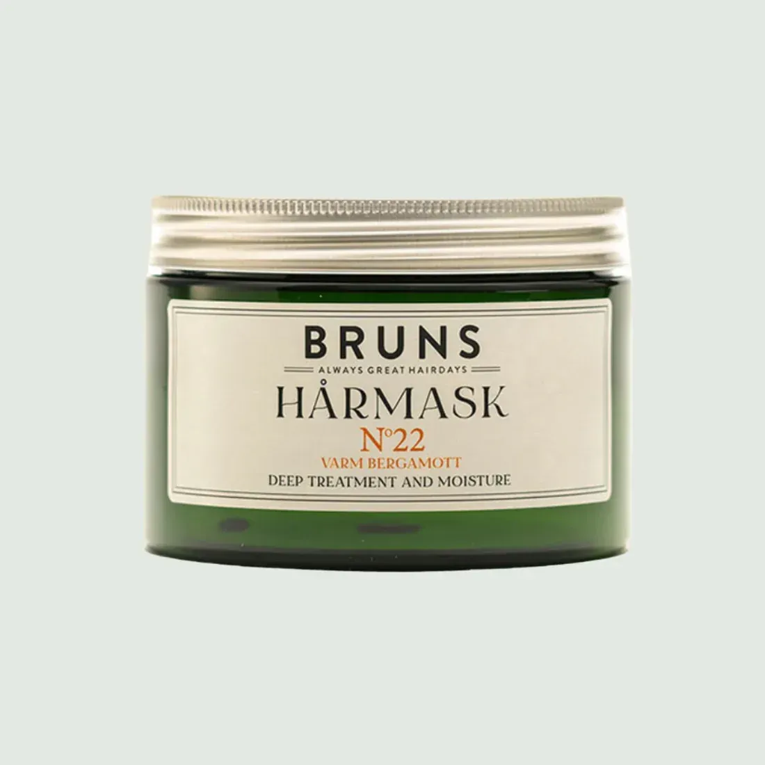 Potje Bruns Haarmasker nr. 22 in crème en donkergroen op een lichte achtergrond.
