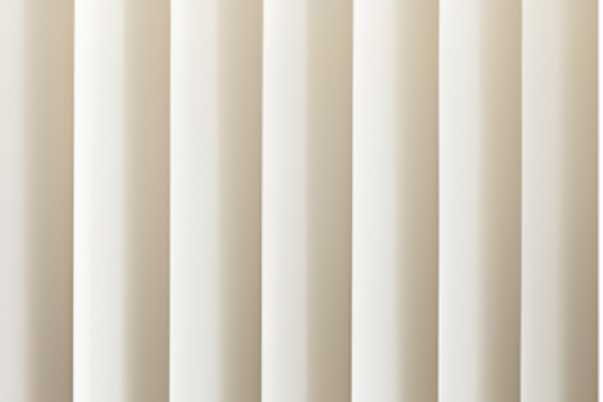 Close-up of beige vertical blinds with soft shadows