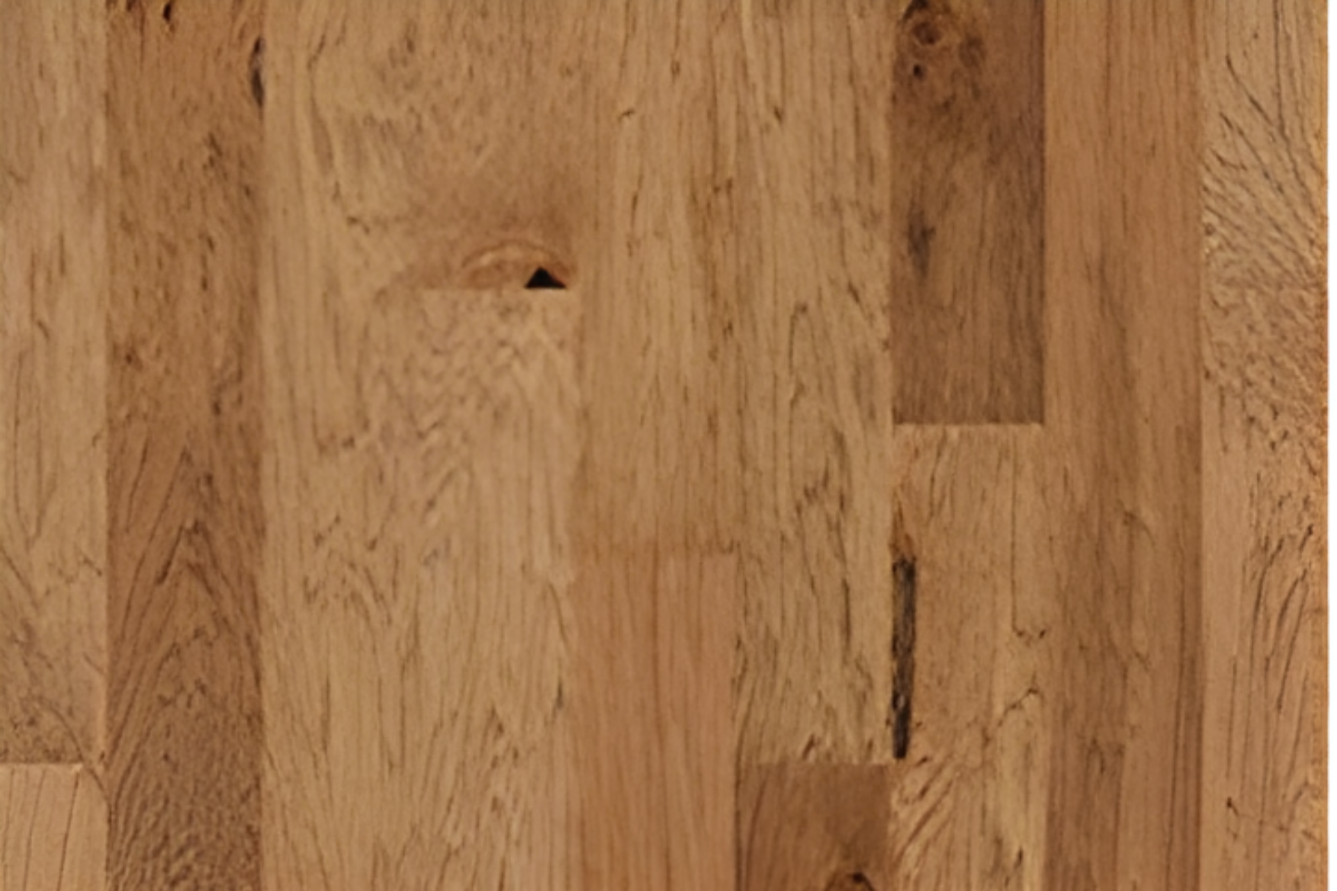 Close-up of a light brown wooden surface with visible grain and a small knot hole