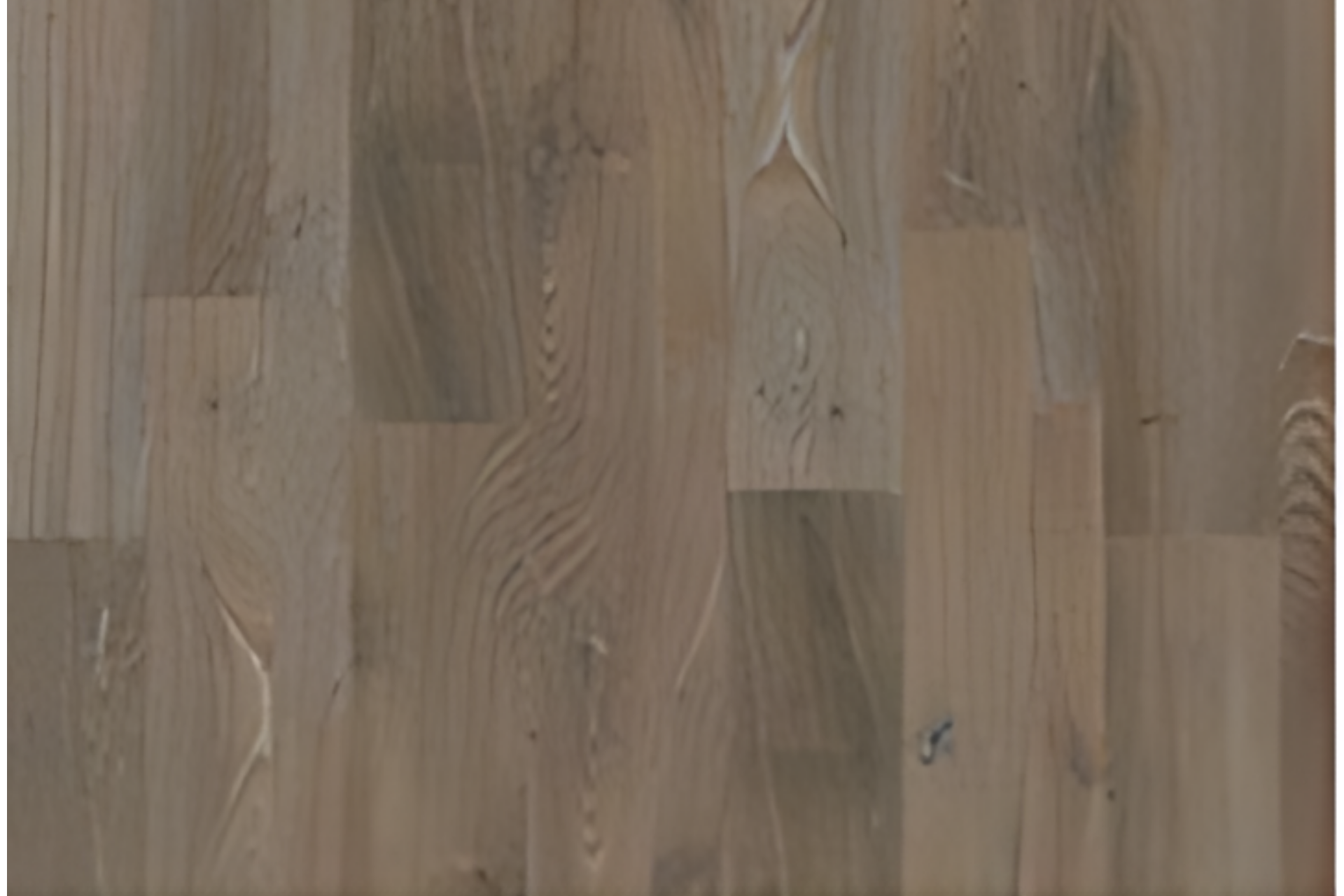 Wooden floorboards with varied brown and gray tones, viewed close up.
