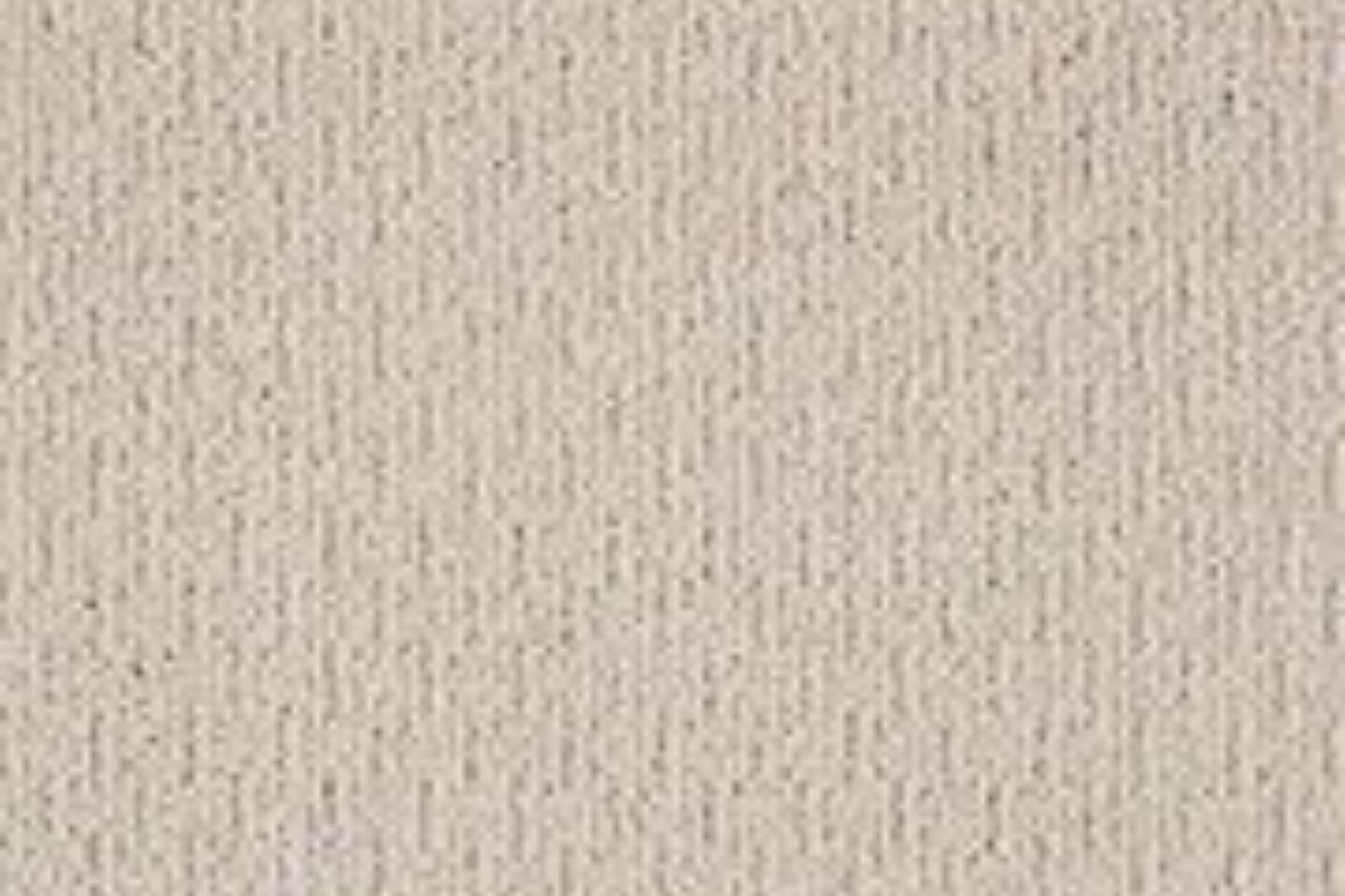 Close-up of a beige textured fabric or wallpaper surface