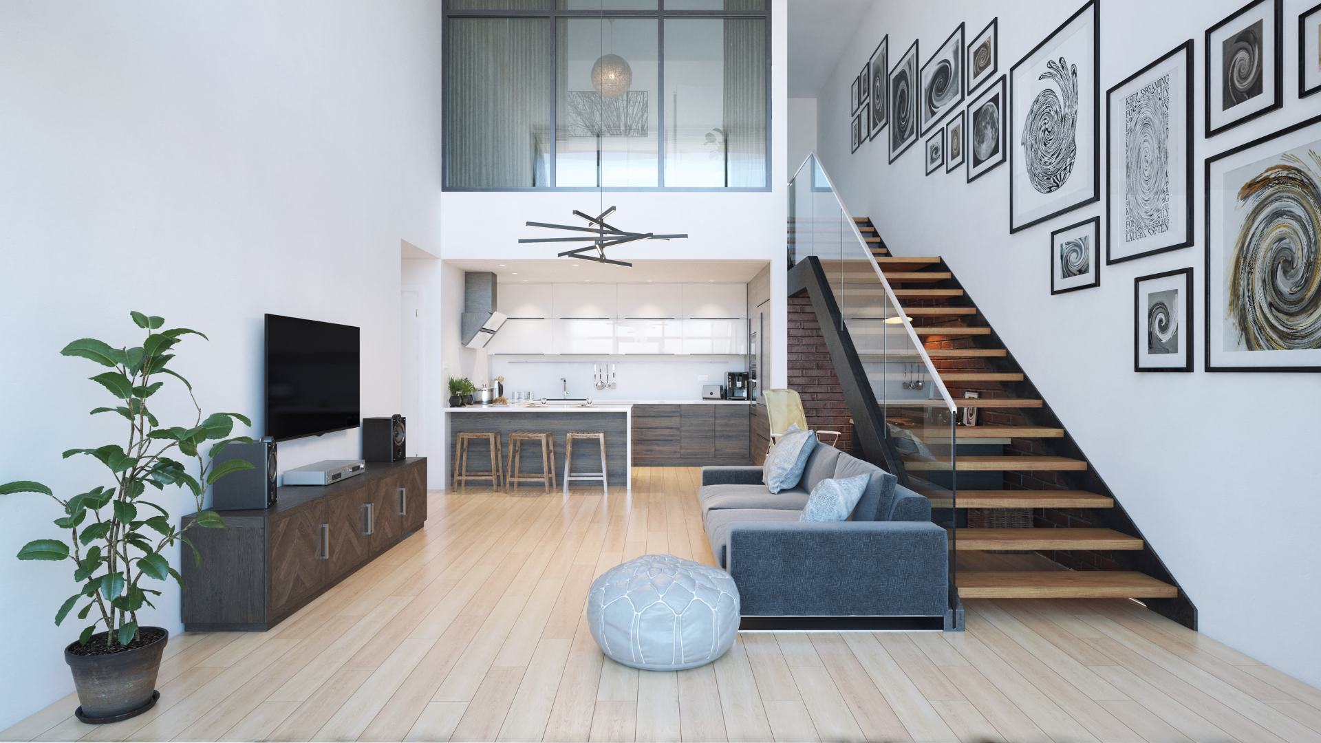 Bright modern loft living room with kitchen, staircase, blue sofa, and framed wall art