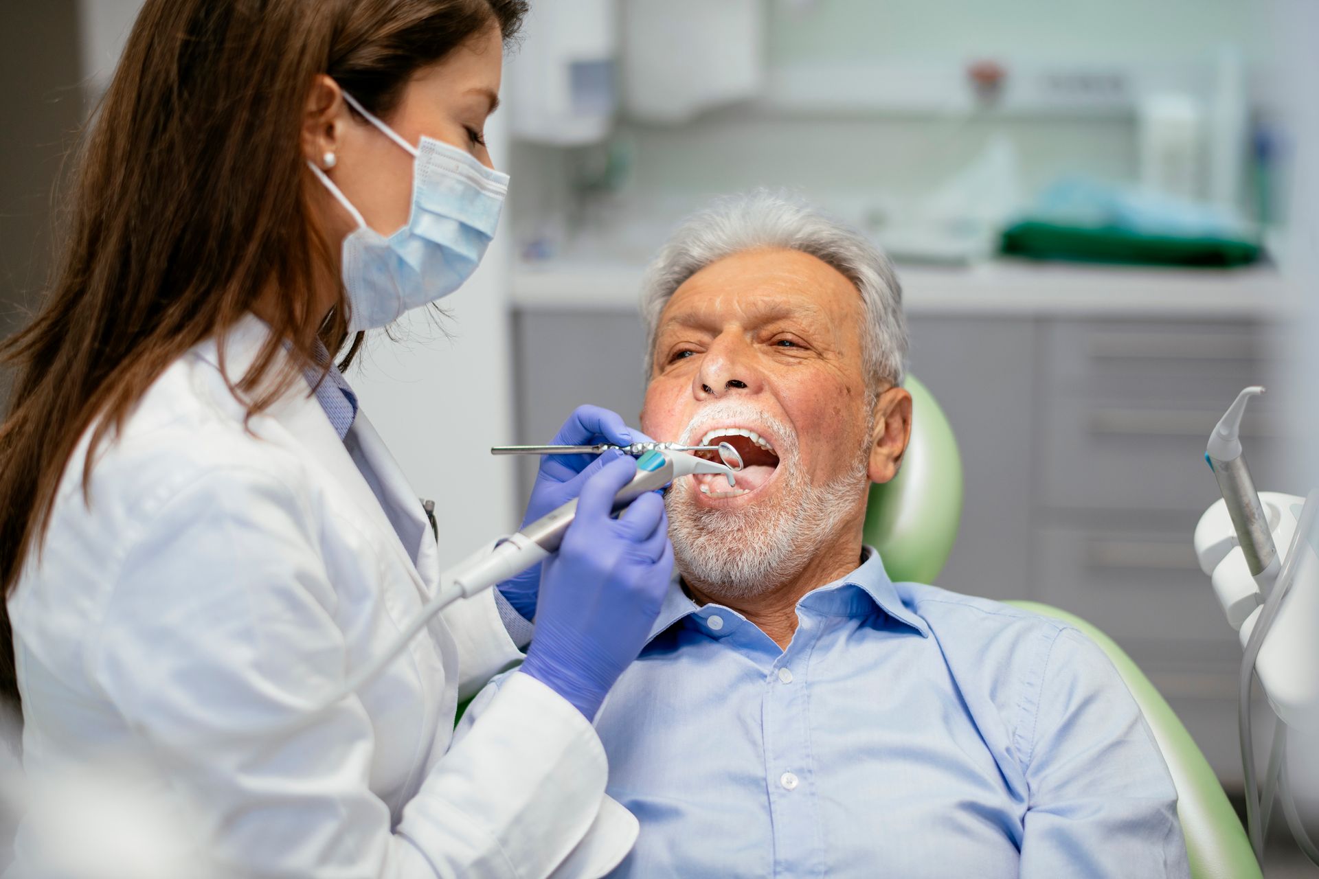 Woman Looking at Her Teeth after Treatment — Davison, MI — Aimee Vakula Rollins DDS