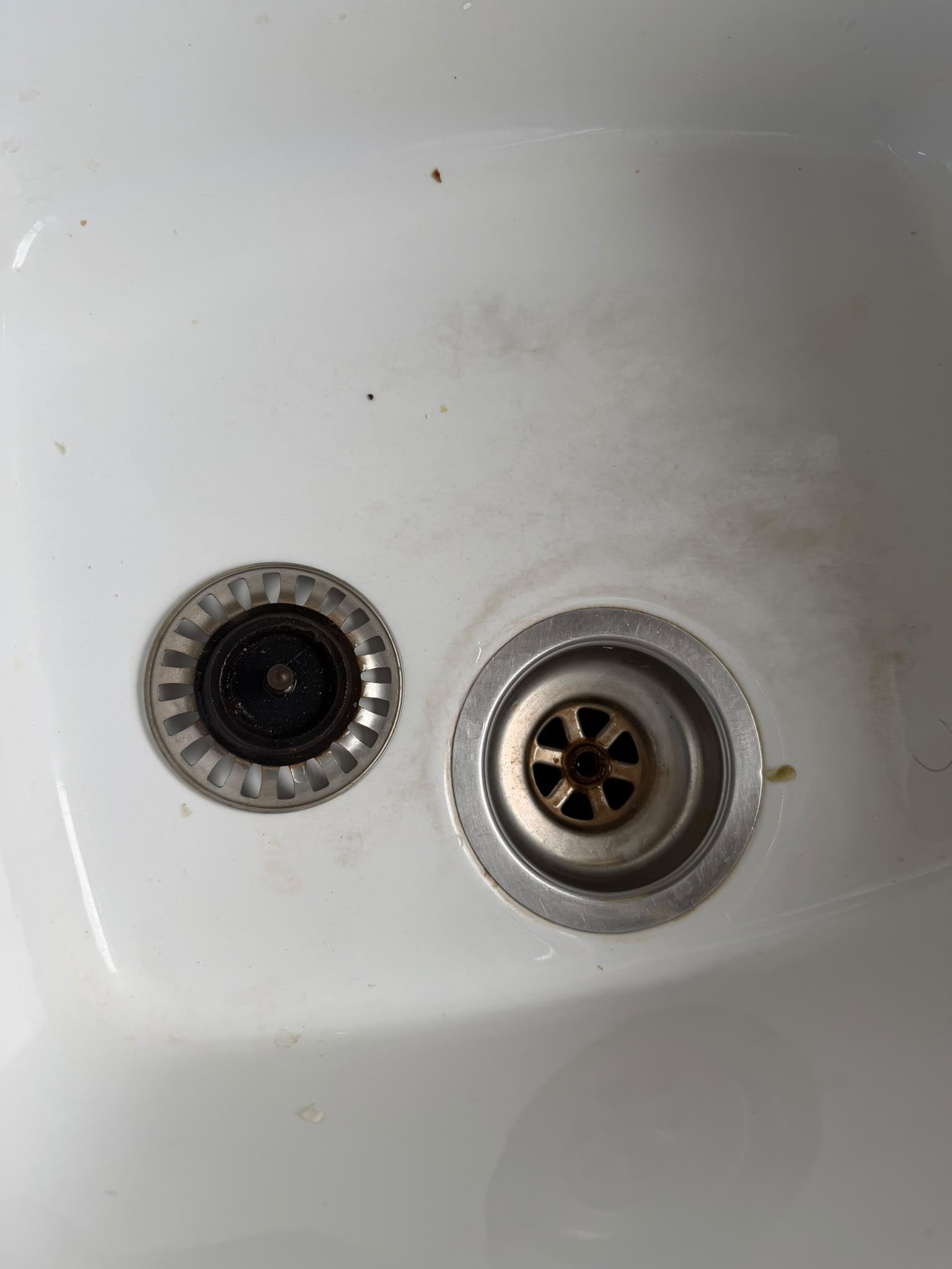 Dirty kitchen sink drain with limescale and grease build-up before a professional deep clean by SafiKleen Solutions in Peterborough