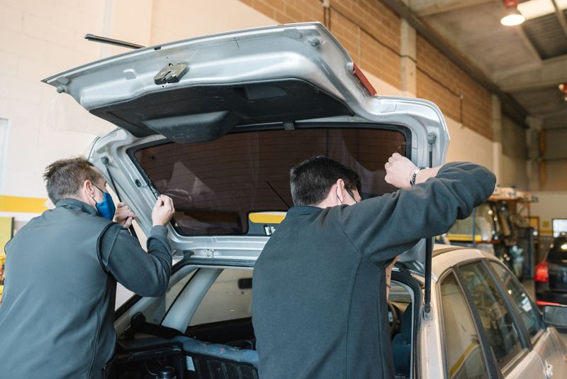 Worker Installing Car Rear Windshield In Bridgeview IL By Route 66 Auto Glass