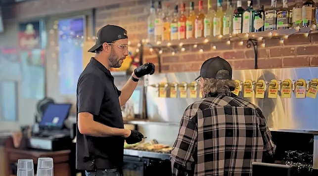 Brew-tiful Lines technician advising a bar manager on draft beer line cleaning, safety, and routine