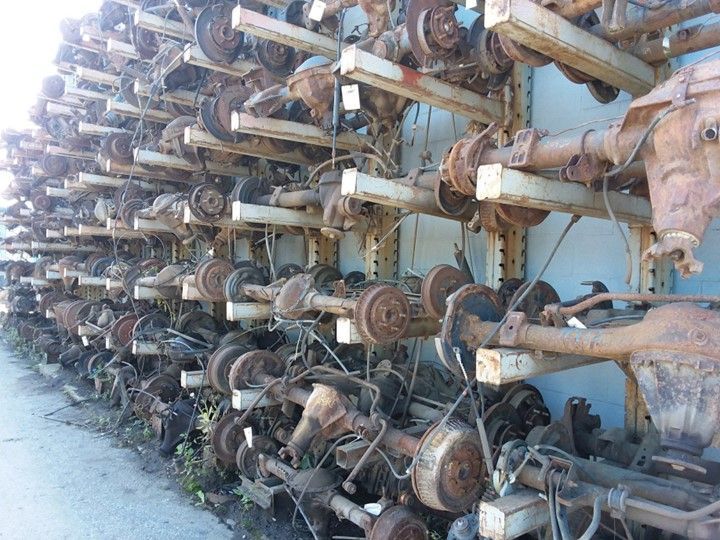 A bunch of rusty parts are stacked on a wall