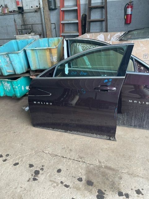 A dark-colored car door labeled