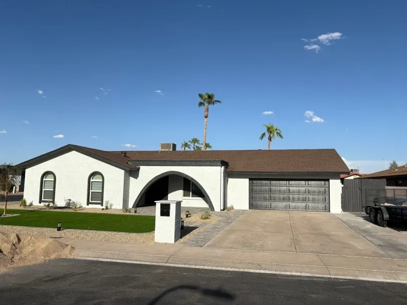 A large house with a garage and a driveway in front of it.