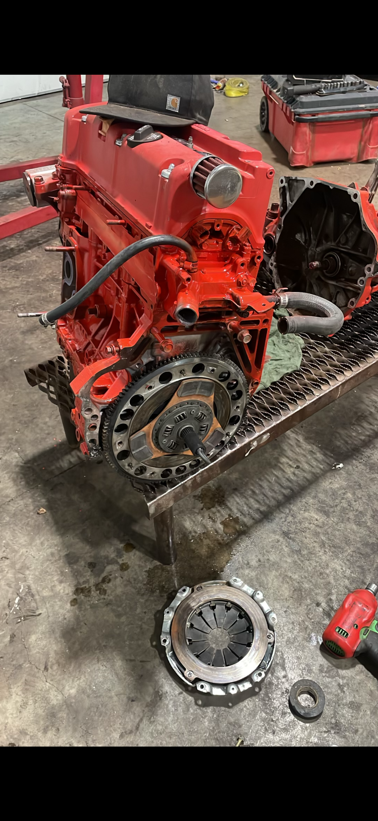 Engine being worked on, clutch parts are in front of it.