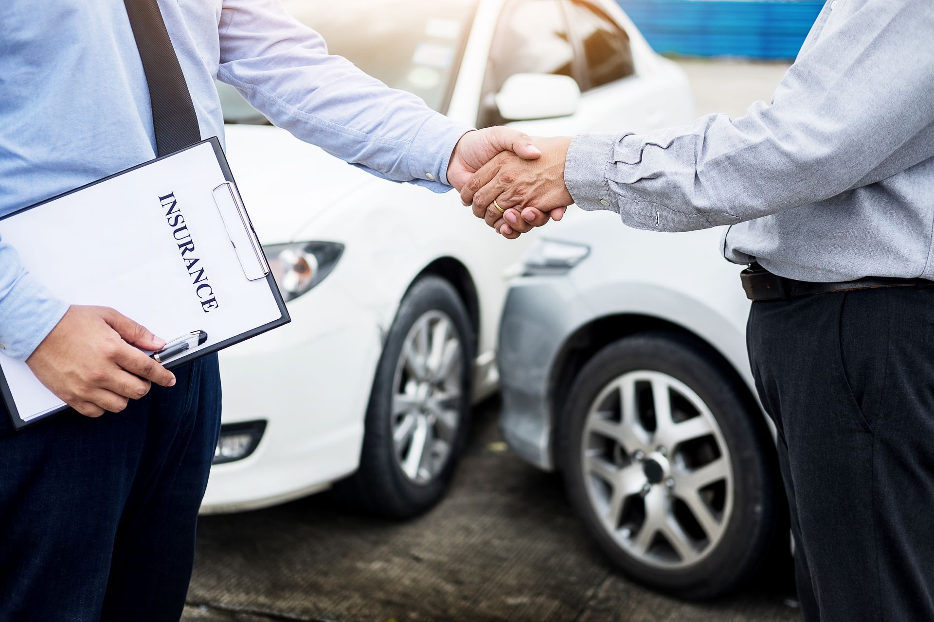Customer shake hand with auto insurance agents after agreeing to terms of insurance.