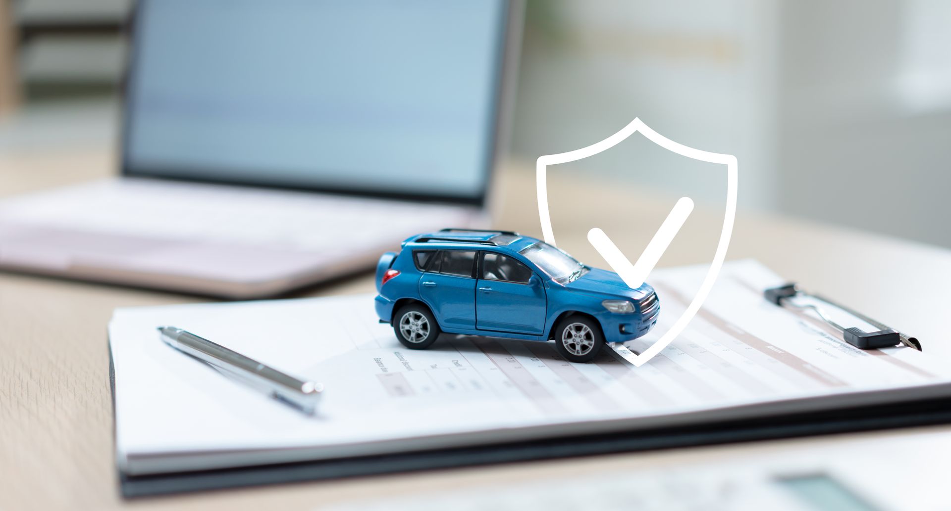 Auto coverage and financial protection symbolized by a car model and shield graphic.