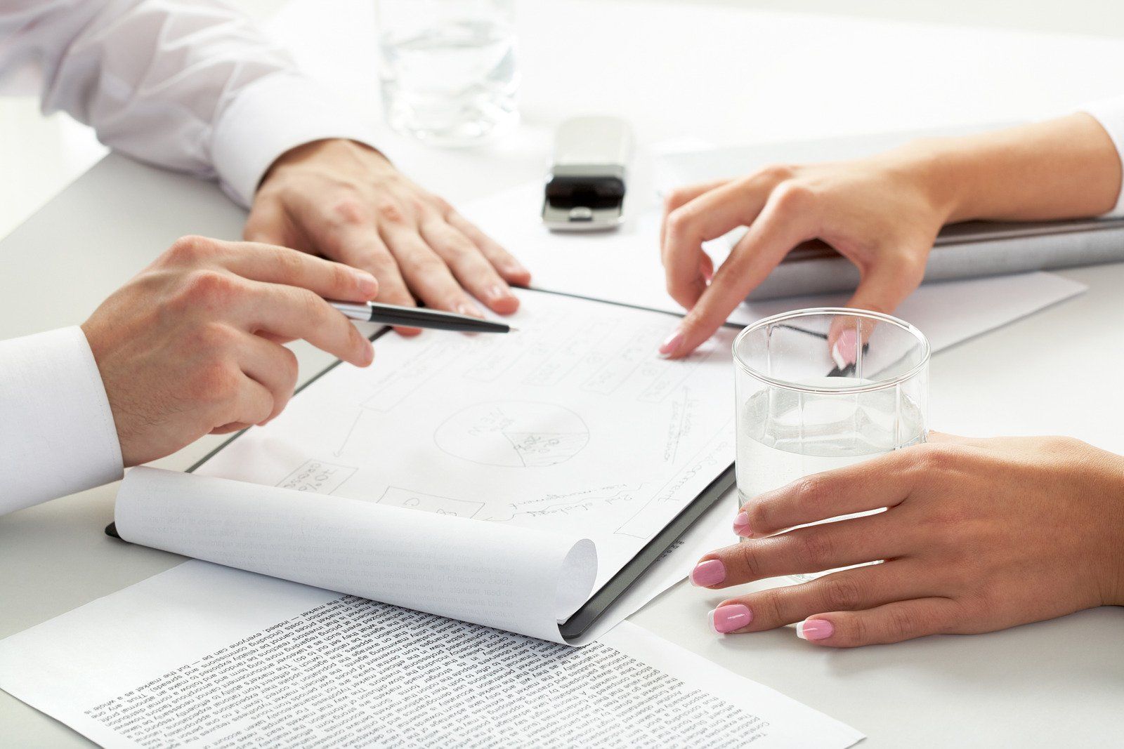A man and a woman are looking at a piece of paper