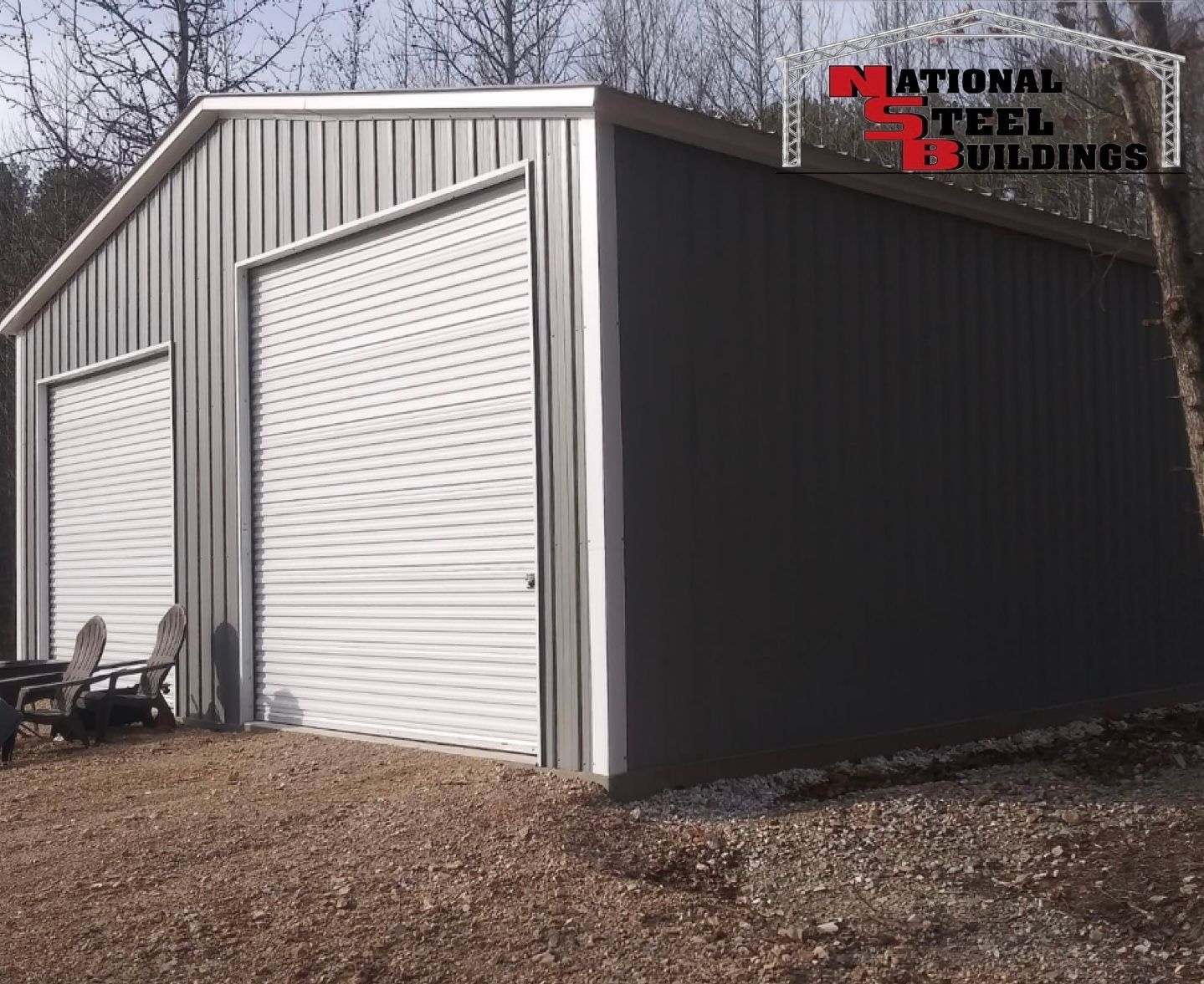 A metal building with two garage doors and a patio area in front of it.