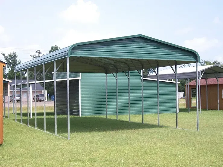 a green carport is in the middle of a grassy field