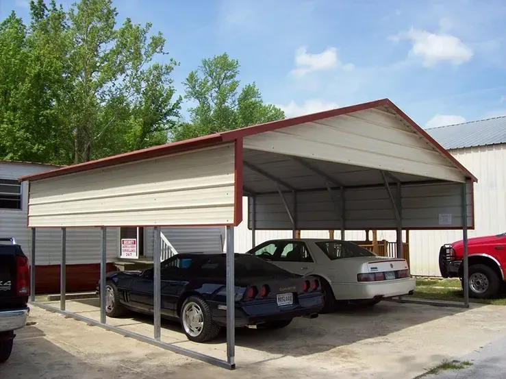 Two cars are parked under a metal carport.