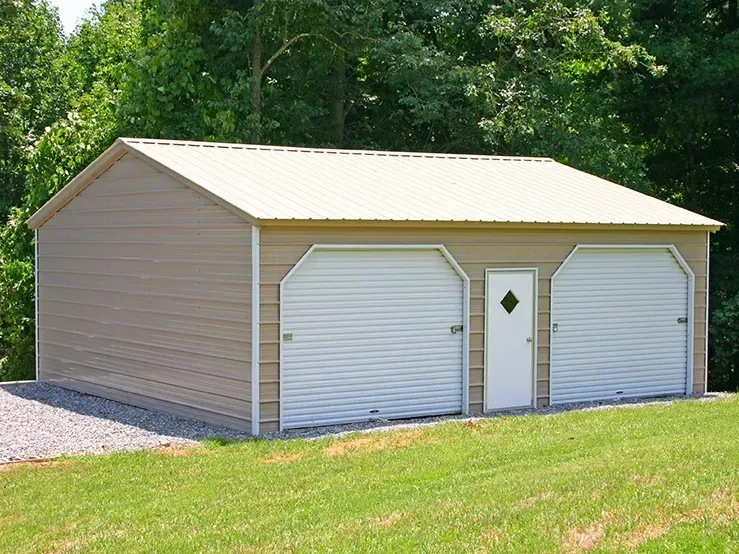 A tan garage with two white garage doors and a white door