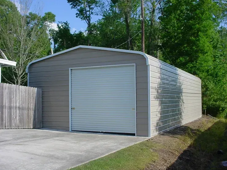 A garage with a white door and a concrete driveway