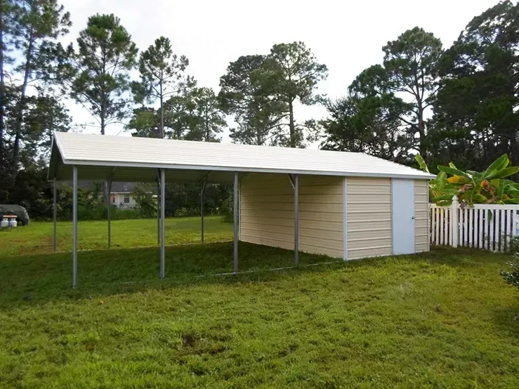 A shed with a white roof is in the middle of a grassy field
