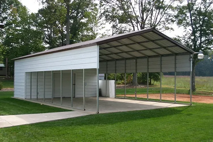A large white metal garage with a brown roof