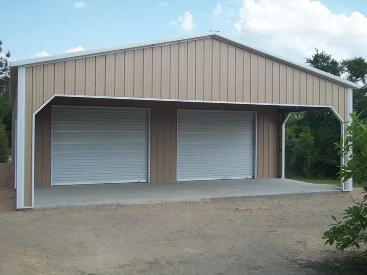 A brown and white garage with two white garage doors