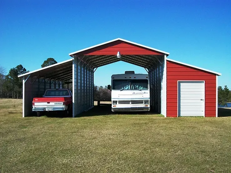 Two cars are parked under a red and white garage