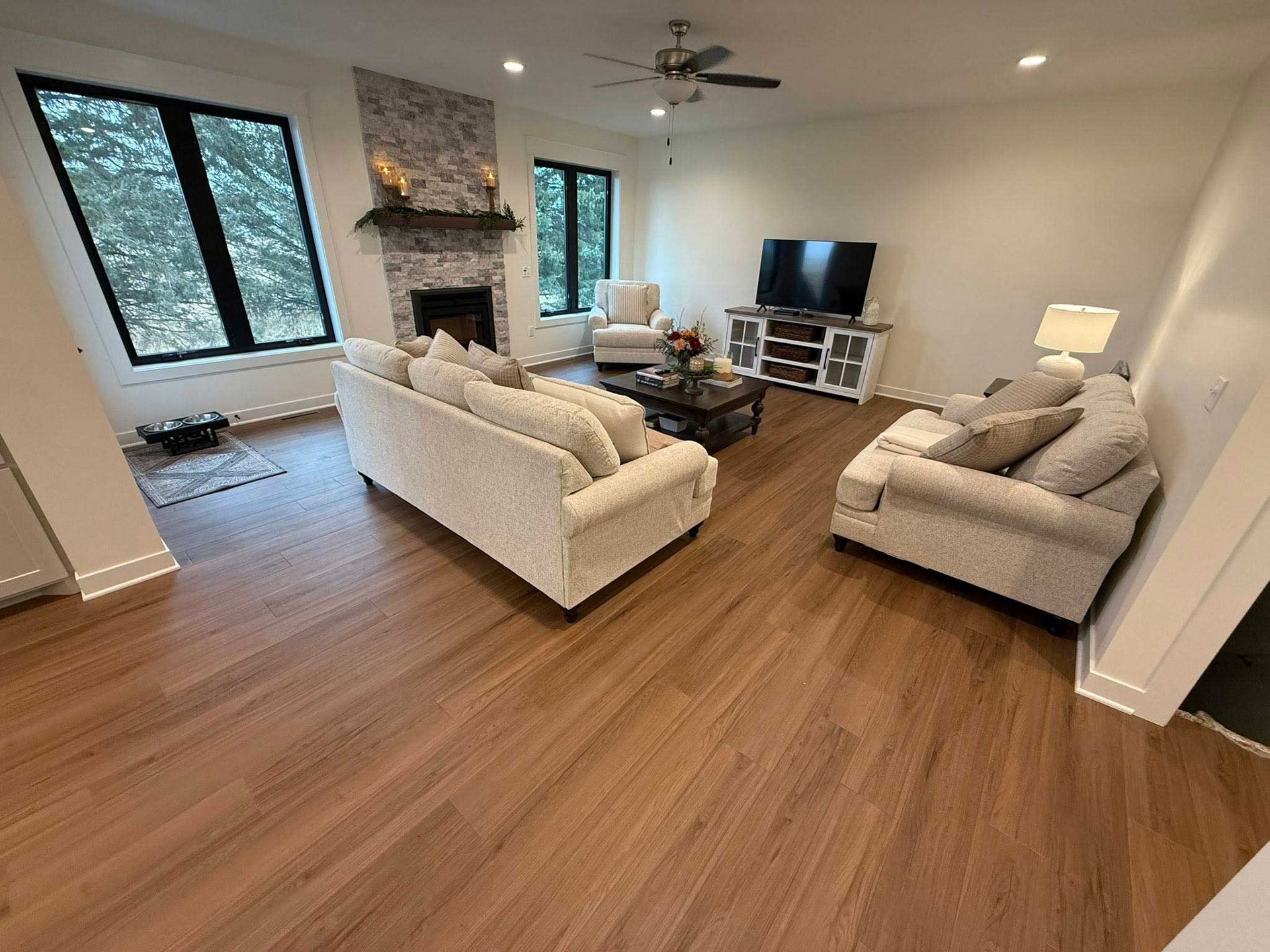 Kitchen with wood cabinets, stainless steel appliances, granite countertops, and wood floors.