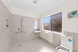 Ensuite in a finished rooming house suite, with vanity, toilet and a glass shower