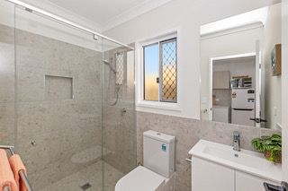 Ensuite in a finished rooming house suite, with vanity, toilet and a glass shower