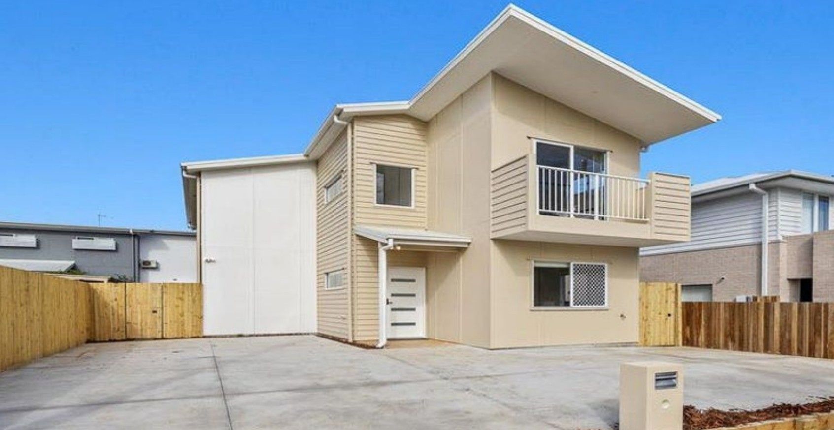 A completed two-storey Smarter Smaller home, with its driveway and front fence