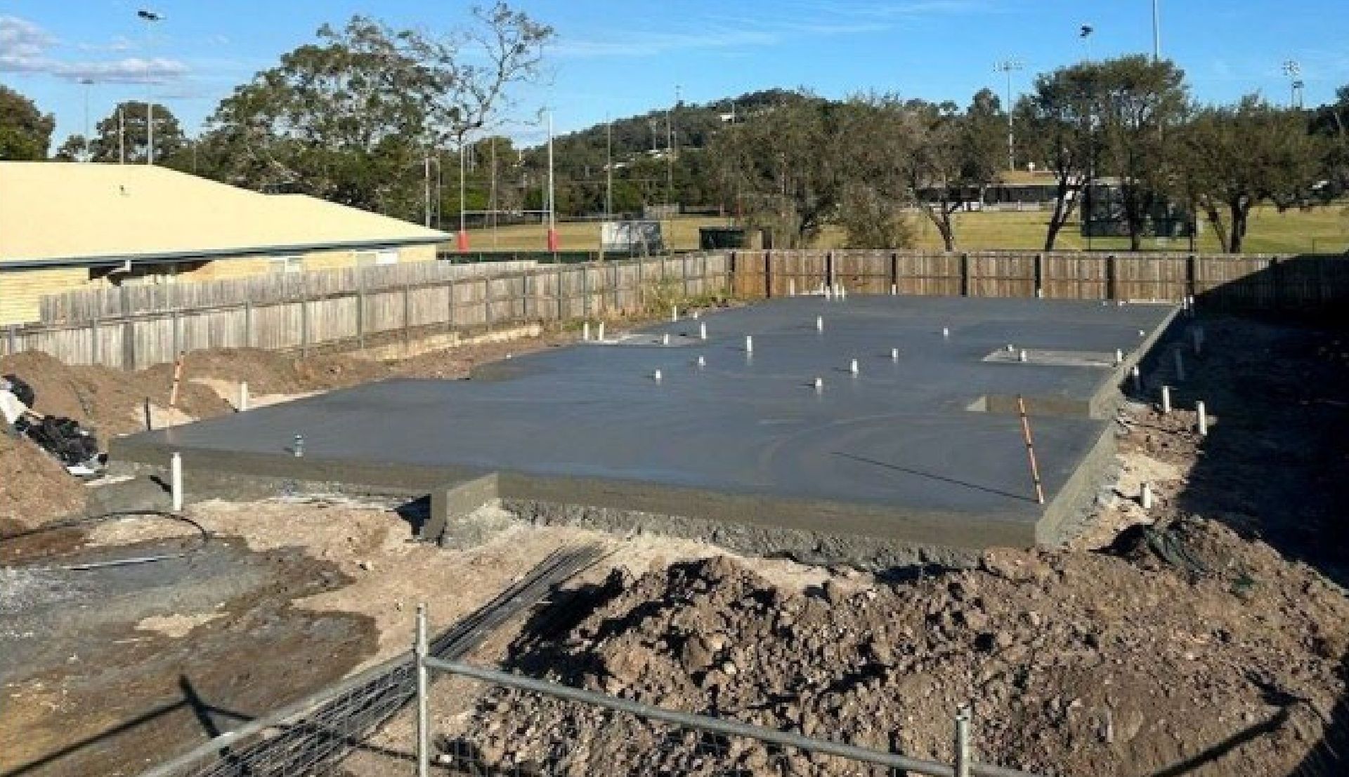 A freshly poured concrete slab on site, ready for the frame to go up