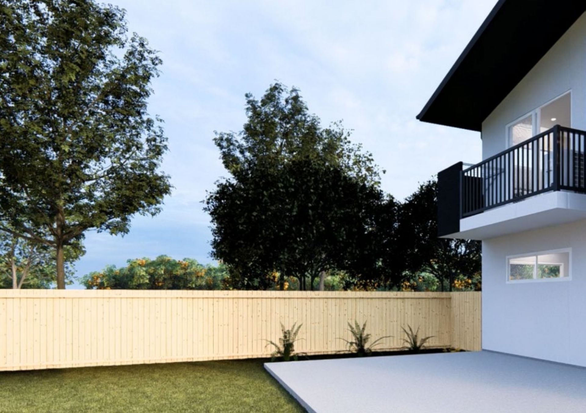 The back garden of a completed home, with a first-floor balcony above