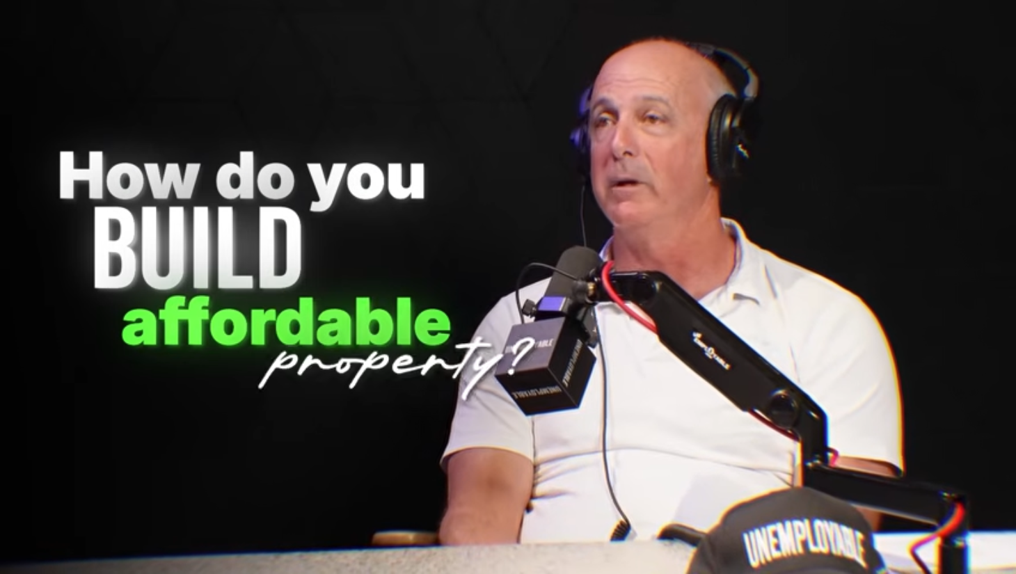 Video thumbnail: Kevin Doodney at a microphone, titled How do you build affordable property?