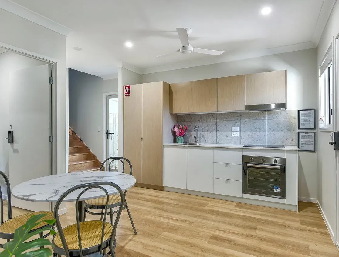 Kitchen and dining area with stairs behind