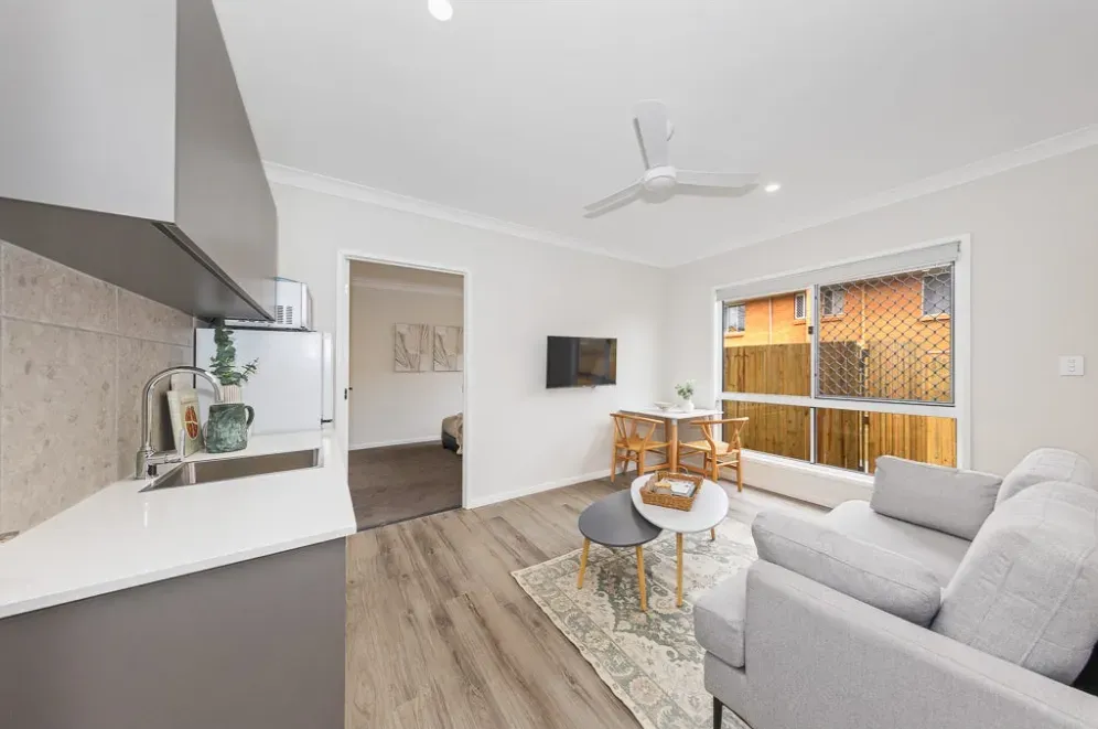 Living and dining area of a finished home, looking through to the entry