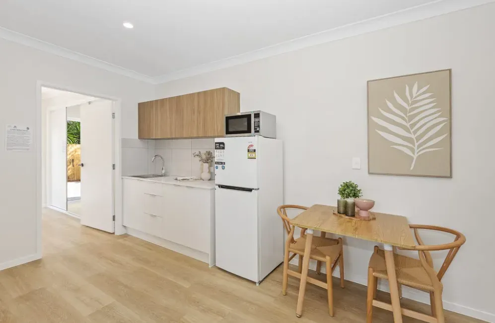 Kitchenette with fridge, microwave and a small dining table