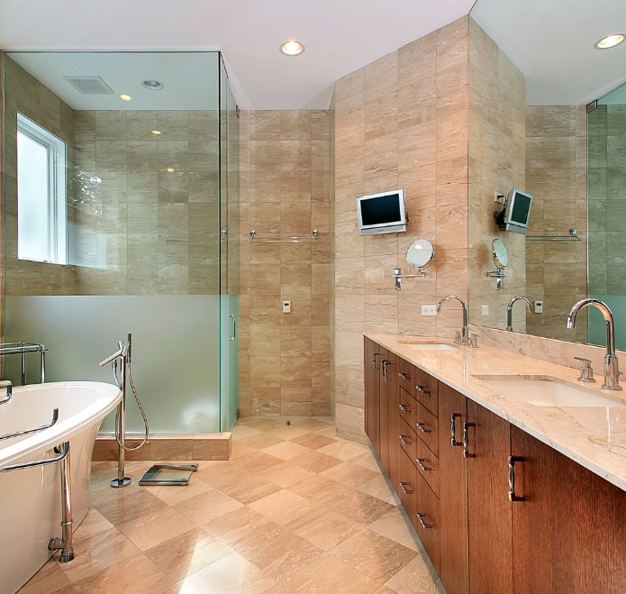 Modern bathroom with glass shower, freestanding tub, and wood vanity with dual sinks