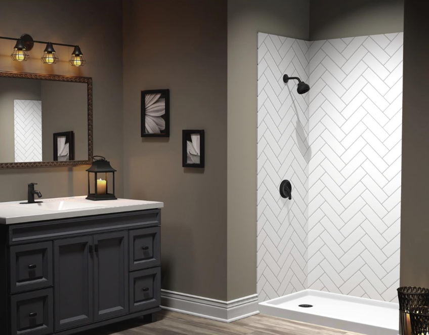 Modern bathroom with dark vanity, mirror, and white tiled shower stall with black fixtures