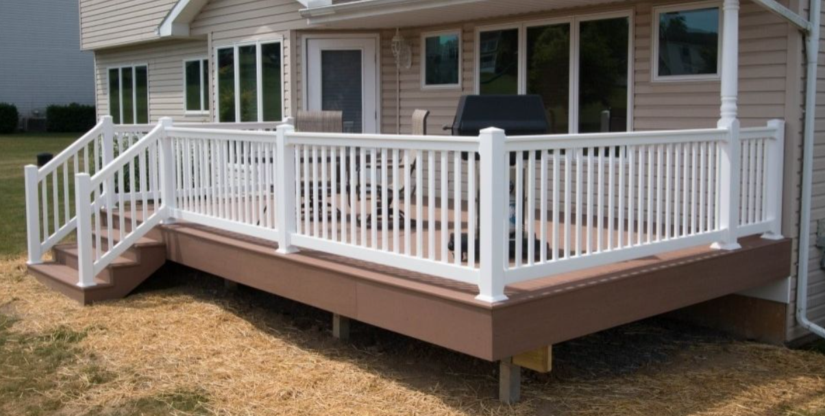 White-railed wooden porch deck attached to a beige house with steps leading down to the yard