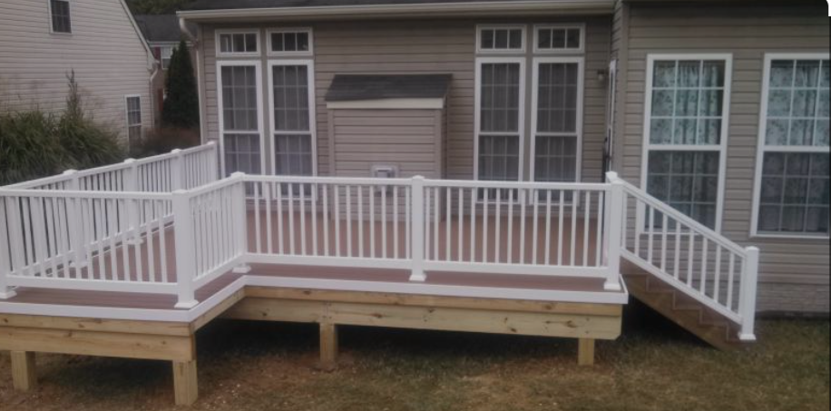 White-railed wooden deck attached to a house, with steps leading down to the yard.