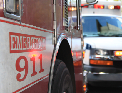 A red and white emergency vehicle with the number 911 on it