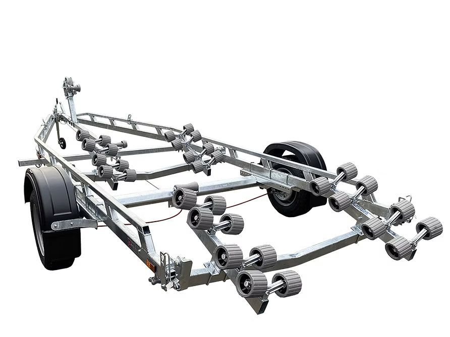 Boat trailer with red rollers, silver frame, and black tires.