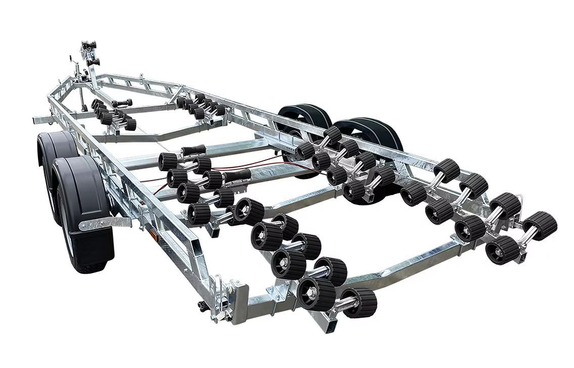 Boat trailer with numerous blue rollers and black tires.