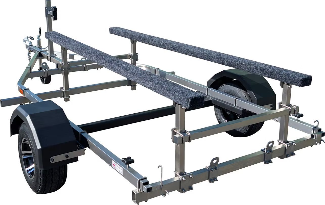 Boat trailer with two padded runners, black fenders, and wheels.