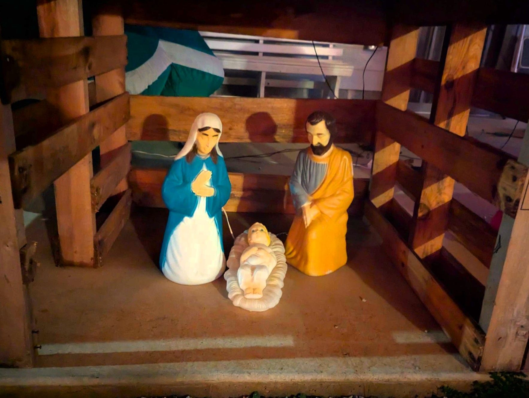 Nativity scene with Mary, Joseph, and baby Jesus in a wooden manger display