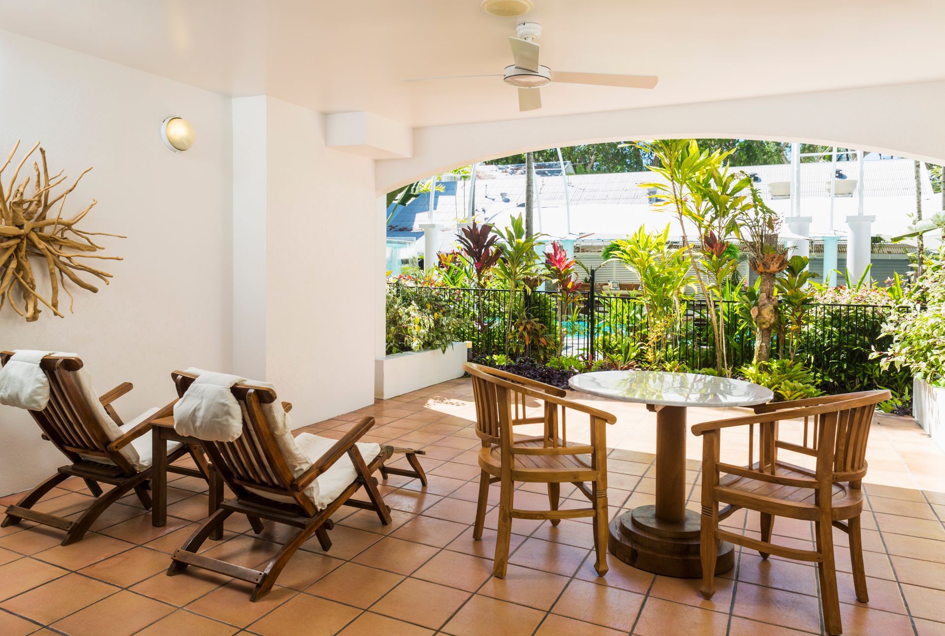 A balcony with a table and chairs overlooking a body of water.